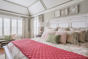 cream bedroom with pink blanket