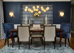 dining room with blue chairs and blue accent wall